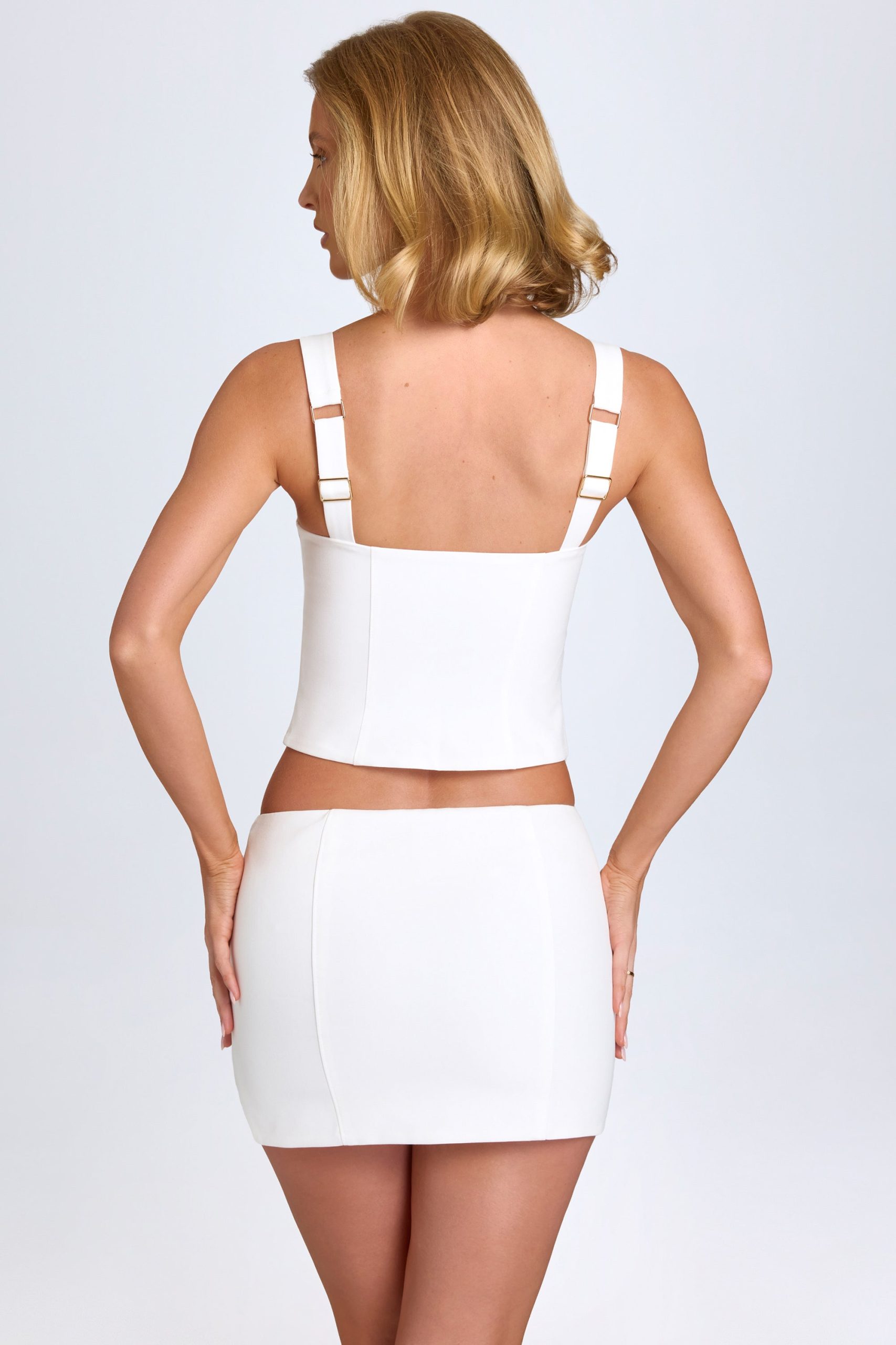 Curved Low-Rise Mini Skirt in White - Image 2