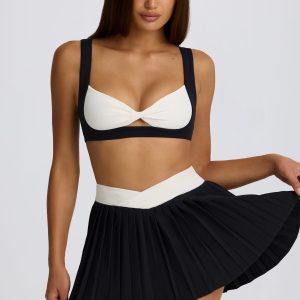 Soft Active Crossover Pleated Mini Skort in Black